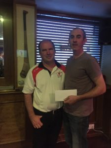 Delighted Michéal accepts his prize from Captain Liam after his brilliance around Faldo course
